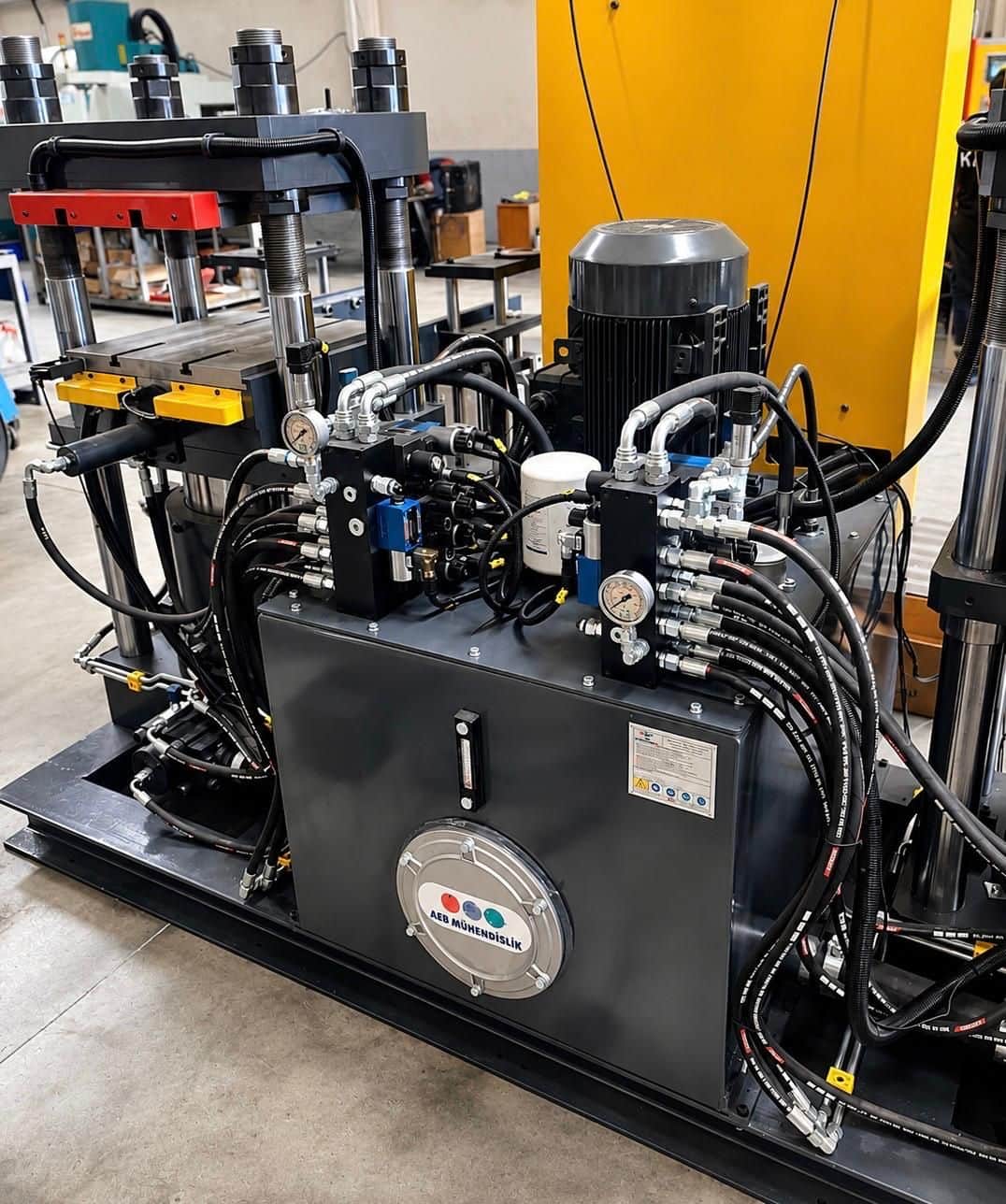 Custom hydraulic press power unit assembled at the AEB Engineering workshop — PLC-controlled manifold blocks and high-pressure system