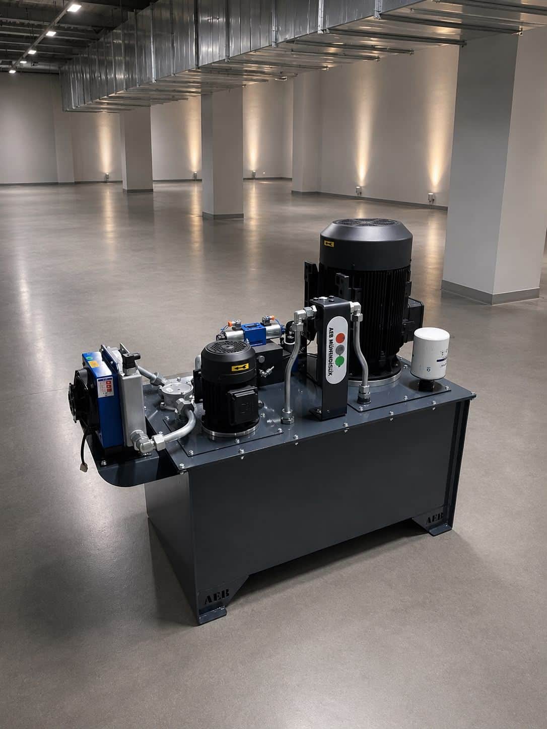 Hydraulic power unit manufactured at AEB Engineering facilities — vertically mounted electric motor, hydraulic block, and compact oil reservoir