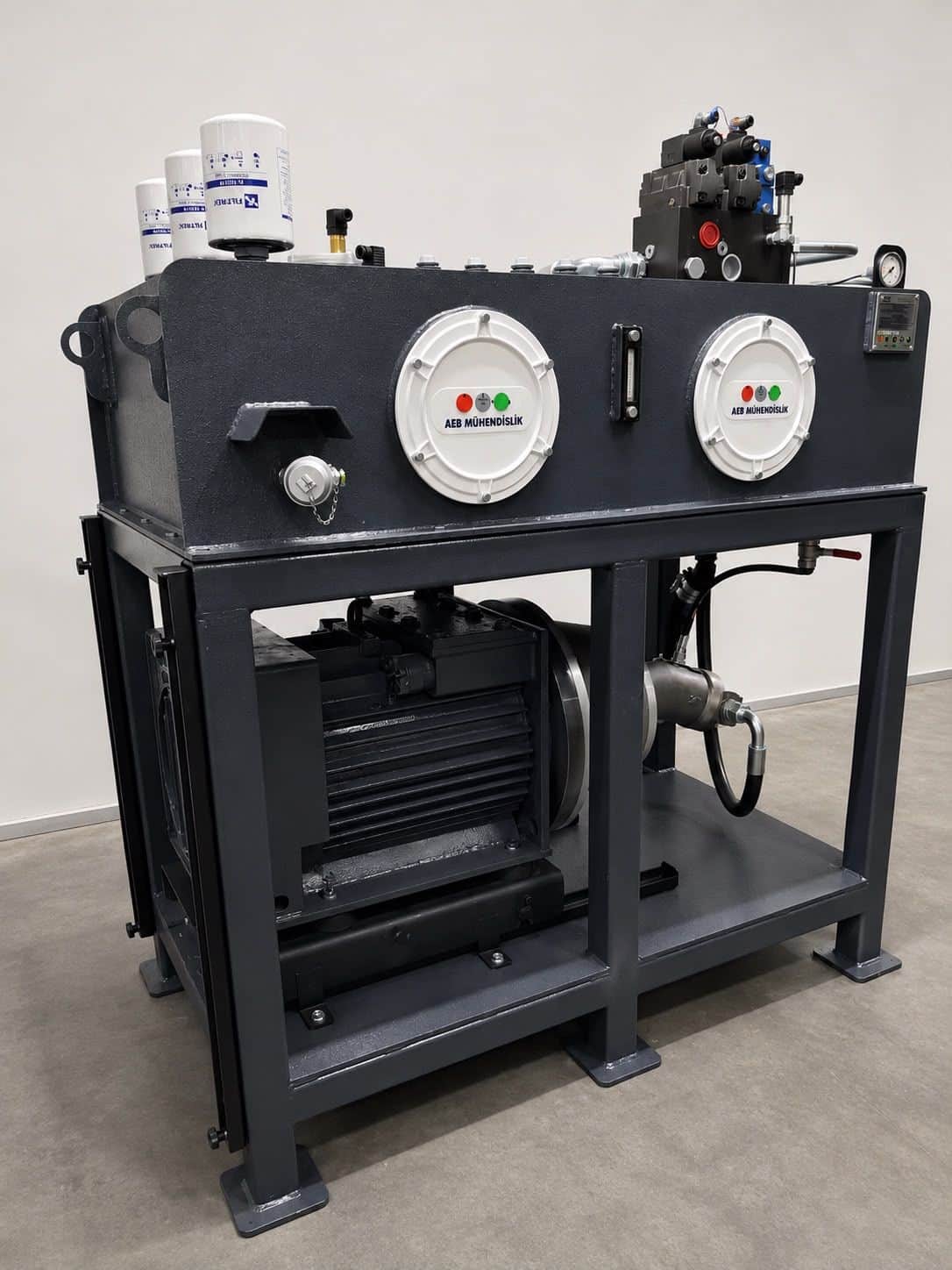 Heavy-duty hydraulic power unit assembled at the AEB Engineering workshop — featuring multiple spin-on filters, level gauge, and body-integrated electric motor