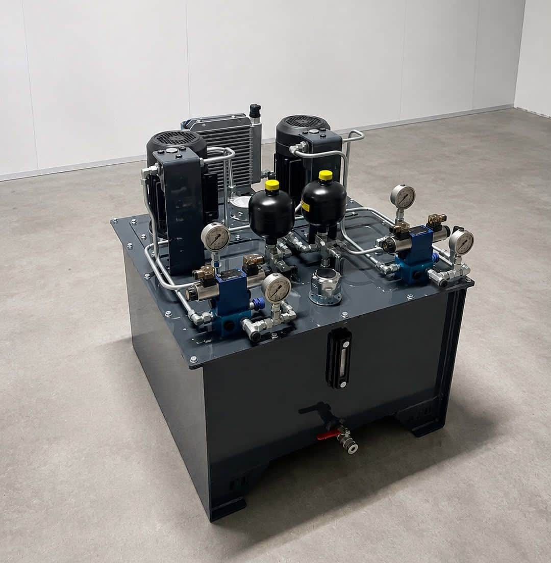 Industrial hydraulic power unit tested at the AEB Engineering workshop — dual-motor system featuring pressure accumulators, air cooler, and proportional valve blocks