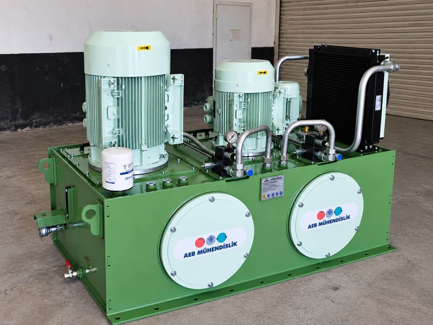 Hydraulic installation integrated onto mobile crane chassis and vertical power unit — heavy-duty unit with dual motors, air cooler, and custom piping system manufactured by AEB Engineering